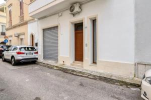 a car parked in front of a building at mono volta by salentolimit in Nardò