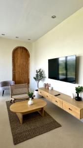 a living room with a large flat screen tv at Mountainparkbali in Baturaja