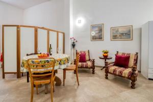 a dining room with a table and two chairs at mono volta by salentolimit in Nardò