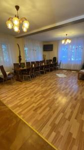 a large room with a wooden floor and chairs at Cabana Iubirii in Ranca