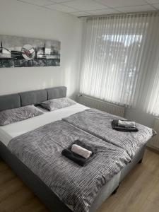 a bedroom with two beds with towels on them at RadlStadl - Brauhaus und Hotel in Kaarst