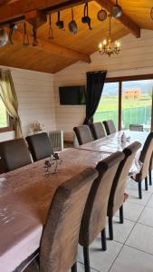 a dining room with a large wooden table and chairs at chez gallon chambres d’hôtes in Vézac