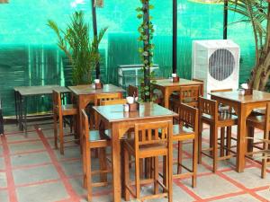 a group of tables and chairs in a restaurant at Bay View Resort in Anjuna