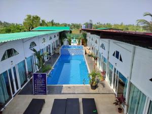 an overhead view of a swimming pool between two buildings at Bay View Resort in Anjuna