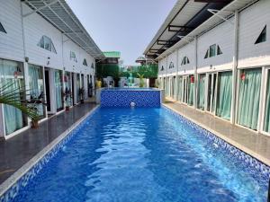 a swimming pool in the middle of a building at Bay View Resort in Anjuna
