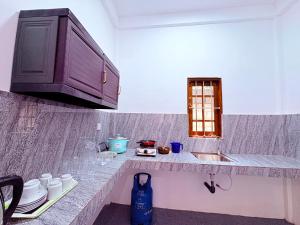 a kitchen counter with a sink and a cabinet at Shan Villa Dambulla in Dambulla +7 photos