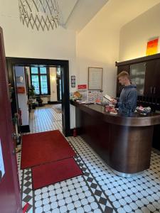 a man standing at a bar in a restaurant at ZM 22, King Room doubleBed in Leverkusen +14 photos