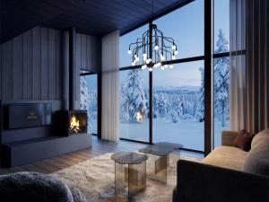 a living room with a fireplace and a chandelier at Arcora Boutique Hotel & Villas in Muonio