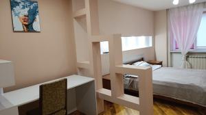 a white room with a bed and a staircase at Home for you in Ternopil