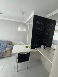 a white desk in a room with writing on the wall at Apto Tranquilo próx ao Litoral Sul Wi-Fi in João Pessoa