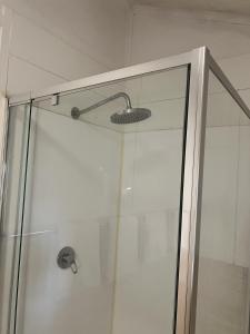 a shower with a glass door in a bathroom at Cosy Heritage Cottage in Ararat +68 photos