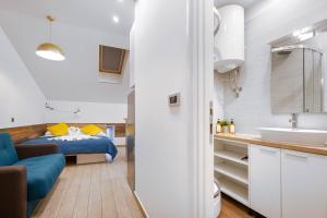 a bathroom with a bed and a sink in a room at Apartments Pomerio Rijeka East in Rijeka