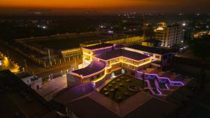 a building with purple lights on it at night at Dembesh Hotel Juba in Juba