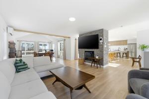 a living room with white furniture and a fireplace at Spa Pool Table - Luxurious pool - Chalet Houefifa in Saint Come