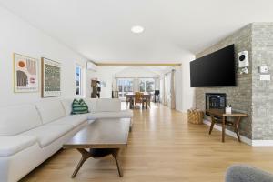 a living room with a white couch and a fireplace at Spa Pool Table - Luxurious pool - Chalet Houefifa in Saint Come