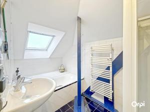 a bathroom with a sink and a bath tub at REF 495 Quéven type 7 manor house in Quéven +29 photos