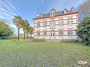 a large white house with a yard in front of it at REF 495 Quéven type 7 manor house in Quéven