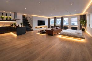 a large living room with a bed and a couch at Hotel Villa Königsgarten in Siebeldingen