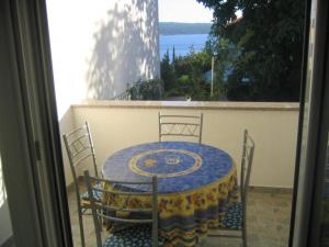 a table and chairs on a balcony with a view of the water at Mia 4 in Crikvenica +15 photos