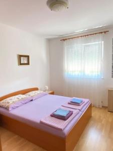 a bedroom with a bed with two towels on it at Mia 4 in Crikvenica