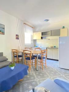 a kitchen and dining room with a table and chairs at Mia 4 in Crikvenica