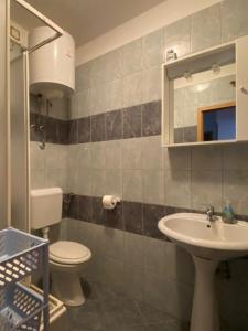 a bathroom with a toilet and a sink at Mia 4 in Crikvenica