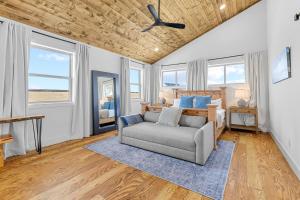 a bedroom with a couch and a bed with windows at Luxury Off-Grid Cabin with Stargazing Deck & Views in Fairplay