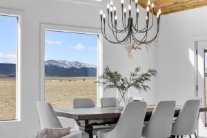 a dining room with a table and chairs and a window at Luxury Off-Grid Cabin with Stargazing Deck & Views in Fairplay