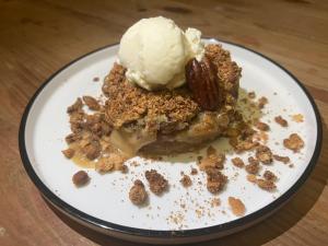 a piece of dessert with ice cream on a plate at Coco Banana in Baie-Mahault
