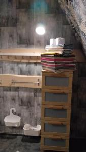 a stack of towels on top of a wooden shelf at DREAM house by the sea in COCOland in Epanomi