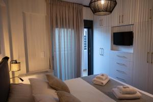 a bedroom with a bed with two towels on it at KLA Luxury Boutique Villa with Pool & Jacuzzi by WESTBOOKING GR in Nikiana +62 photos