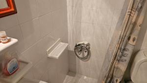 a bathroom with a shower with a toilet and a sink at Βωλίτης Ξενώνας - Παραδοσιακό Καφενείο Ζαγορίου in Papingo +40 photos