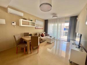 a living room with a table and a couch at CJ186 - Ciudad Jardin I, Prime - ServHouse in El Borseral