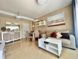 a living room with a couch and a table at CJ186 - Ciudad Jardin I, Prime - ServHouse in El Borseral