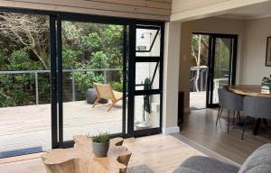 a living room with sliding glass doors leading to a deck at Shade & Salt in Sedgefield