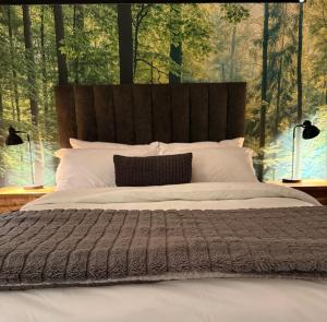 a bedroom with a large bed with a large window at Shade & Salt in Sedgefield
