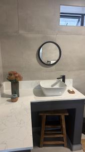 a bathroom with a sink and a mirror at Shade & Salt in Sedgefield +17 photos