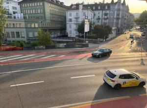 a police car driving down a city street at Shared Apartment in central Luzern in Lucerne