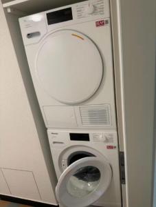 a washer and dryer in a small room at Shared Apartment in central Luzern in Lucerne