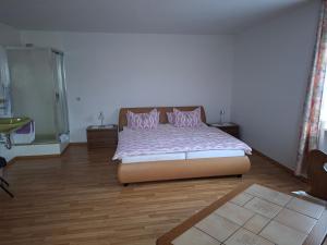 a bedroom with a bed with pink pillows on it at Gästezimmer Hagenschieß in Pforzheim