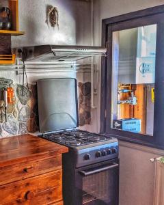 a stove top oven in a kitchen with a window at Thee&Thou Cottage in Breaza