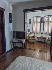 a living room with a flat screen tv and a couch at Thee&Thou Cottage in Breaza