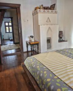 a bedroom with a bed and a fireplace at Thee&Thou Cottage in Breaza