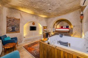 a bathroom with a tub and a bed in a room at Grand Elite Cave Suites in Göreme +49 photos