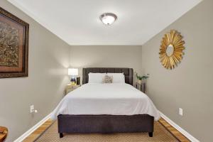 a bedroom with a bed and a mirror on the wall at Oglethorpe Manor Garden Level in Savannah +36 photos