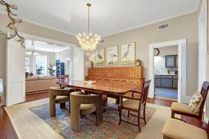 a dining room with a wooden table and chairs at Oglethorpe Manor Main House in Savannah