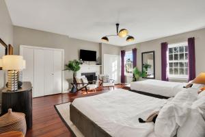 a large bedroom with two beds and a living room at Oglethorpe Manor Main House in Savannah