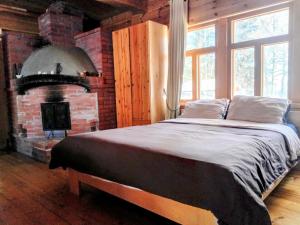 a bedroom with a bed and a brick fireplace at Riverside Cottage Äänekoski Sauna Hot Tub Northern Lights in Äänekoski +137 photos
