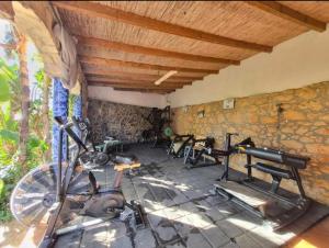a room with a gym with a bike in it at Sunset Lagoon House in Lagoa