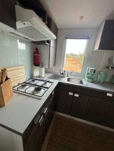 a small kitchen with a stove and a sink at Sunset Lagoon House in Lagoa +19 photos
